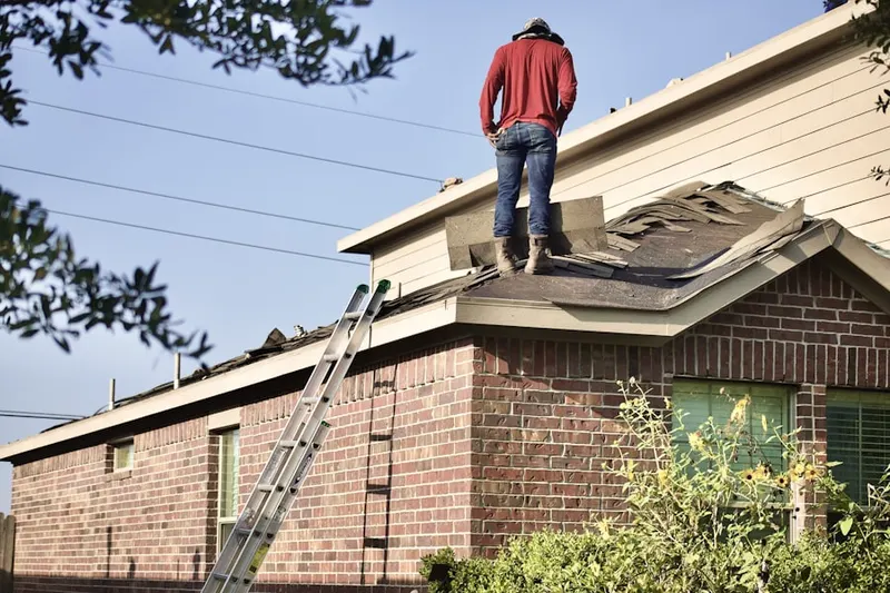 Professional roofer working on a residential roof in Reisterstown